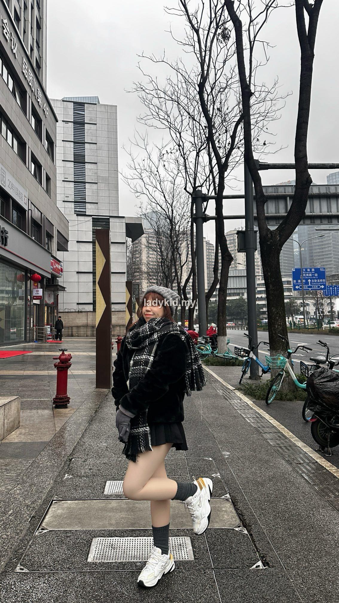 Customer black outfit try-on street photo